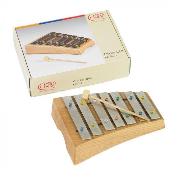 Wooden glockenspiel with metal bars and a wooden mallet in front of a Choroi branded box
