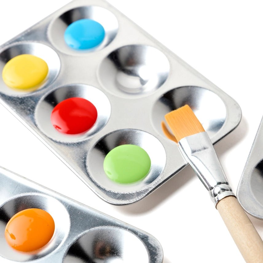 Metal paint palette with colorful paint samples and a brush on a white background