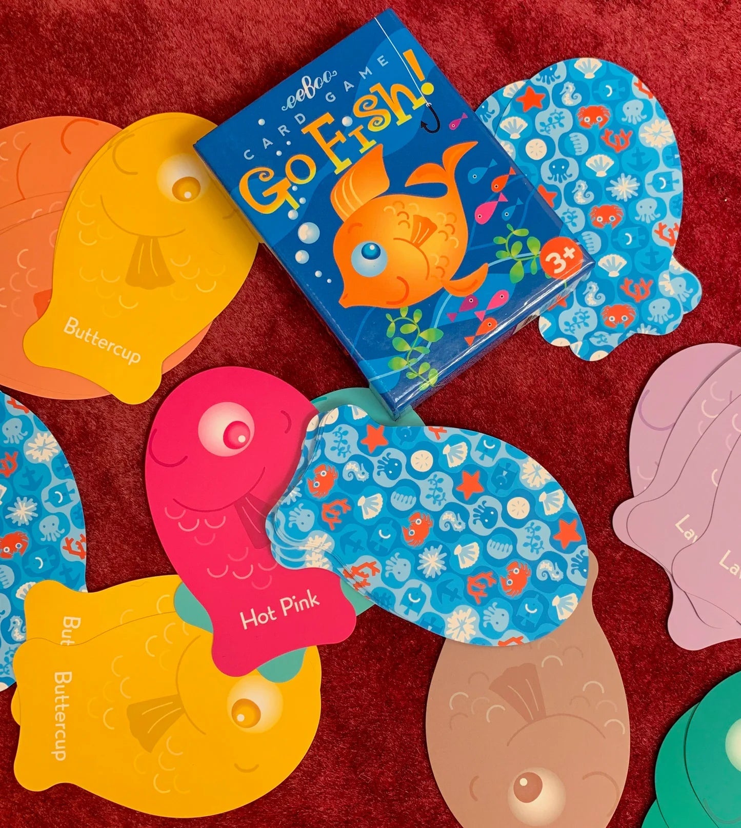 Children's card game 'Go Fish!' with colorful cards on a red background