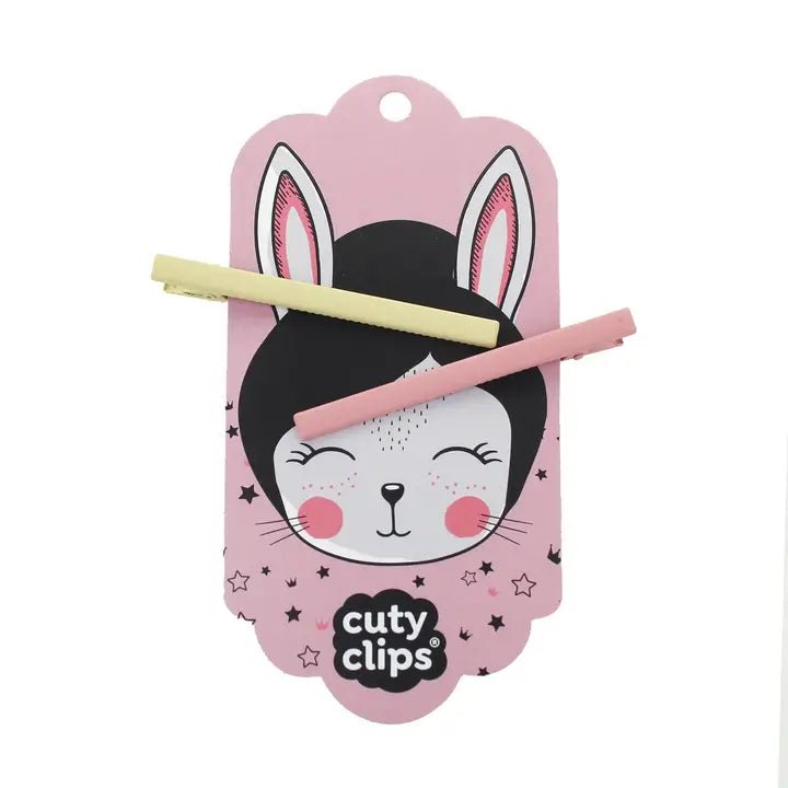Yellow and pink hair clips on Cuty Clips branded packaging with white background
