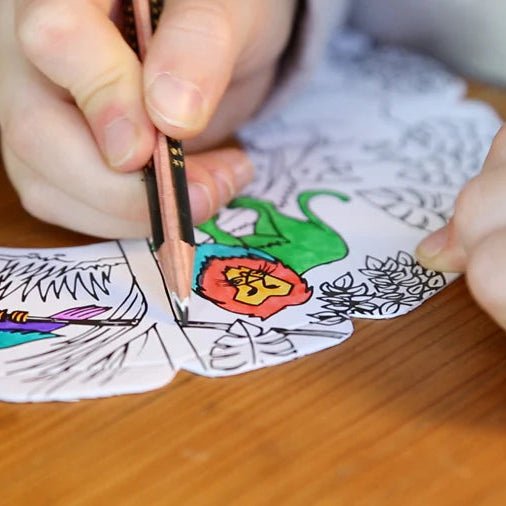 Close up of child coloring in safari themed throwing disc.