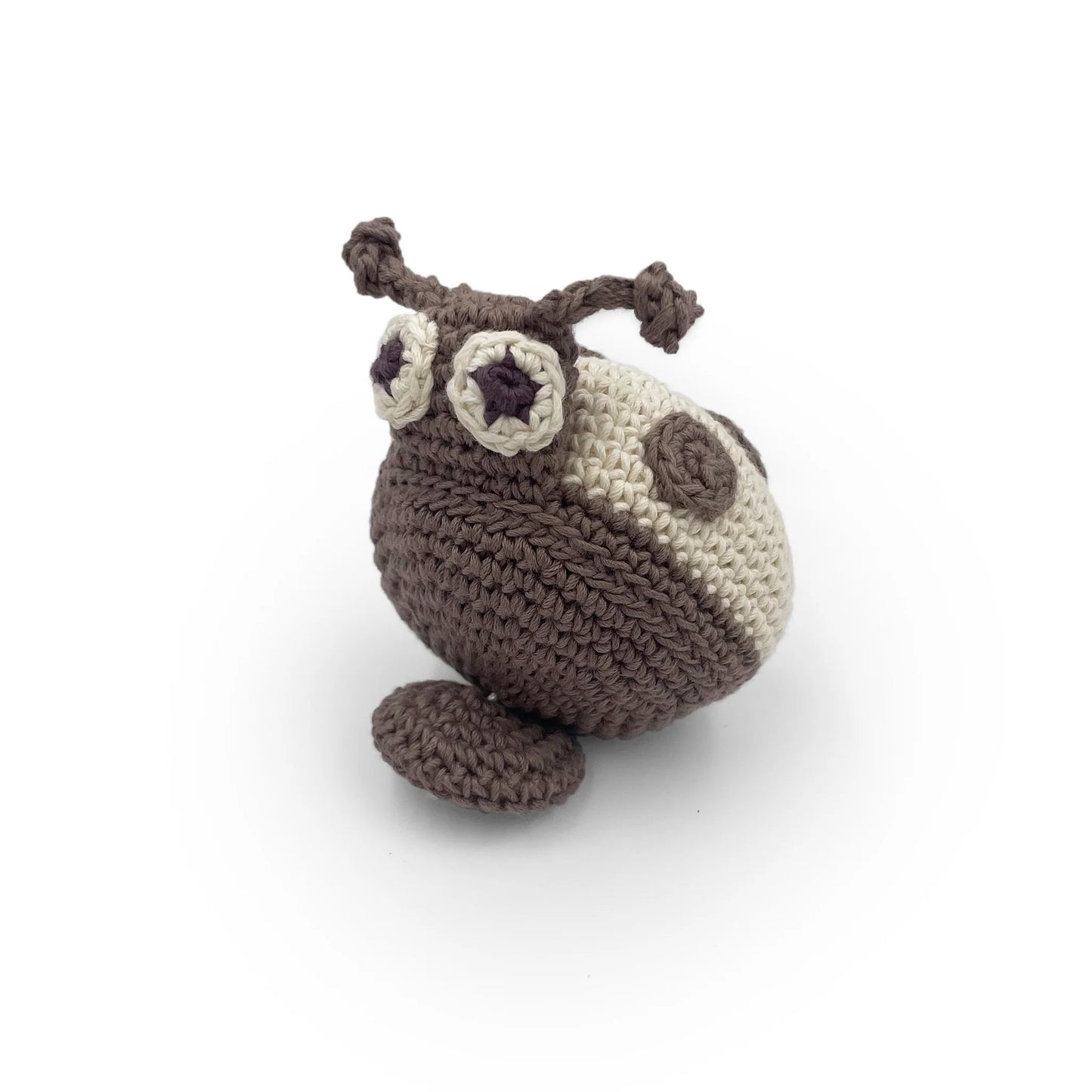 Crocheted beige and gray ladybug toy with a pull-string on a white background