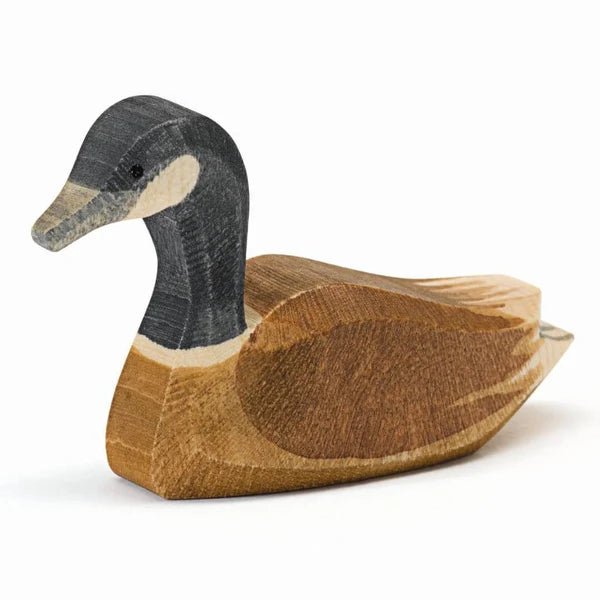 Wooden Canada Goose swimming figurine on a white background