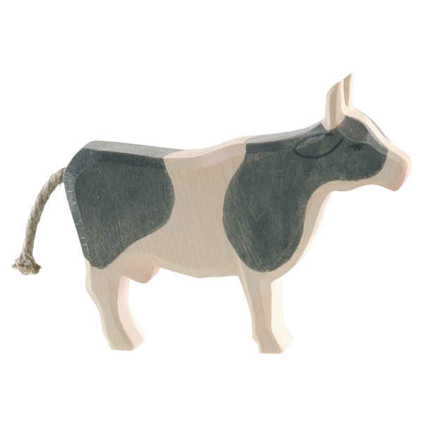 Wooden cow figure with black spots on a white background