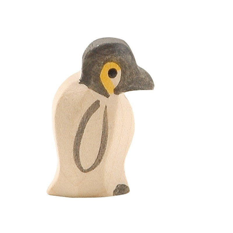 Wooden penguin figurine on a white background