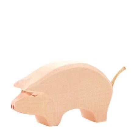 Wooden pink pig on a white background