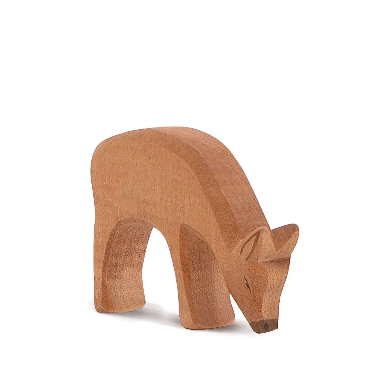Wooden red deer eating on a white background