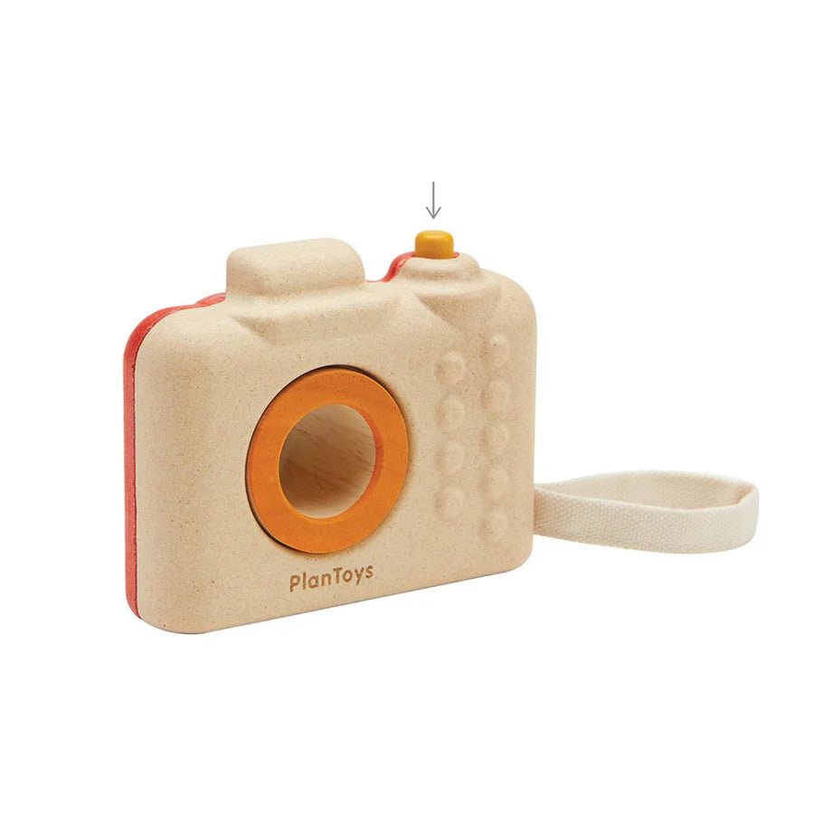 Back side of wooden toy camera with orange lens and red accents on a white background, branded 'PlanToys'.