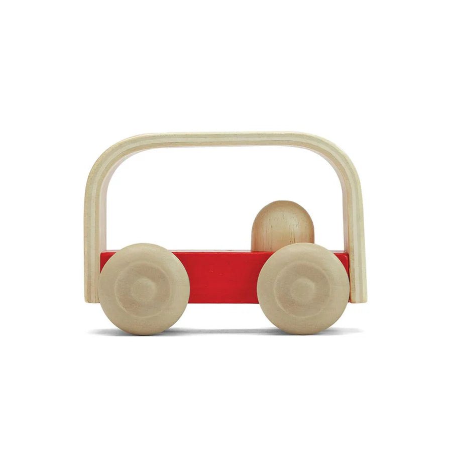 Side view of red toy bus on a white background