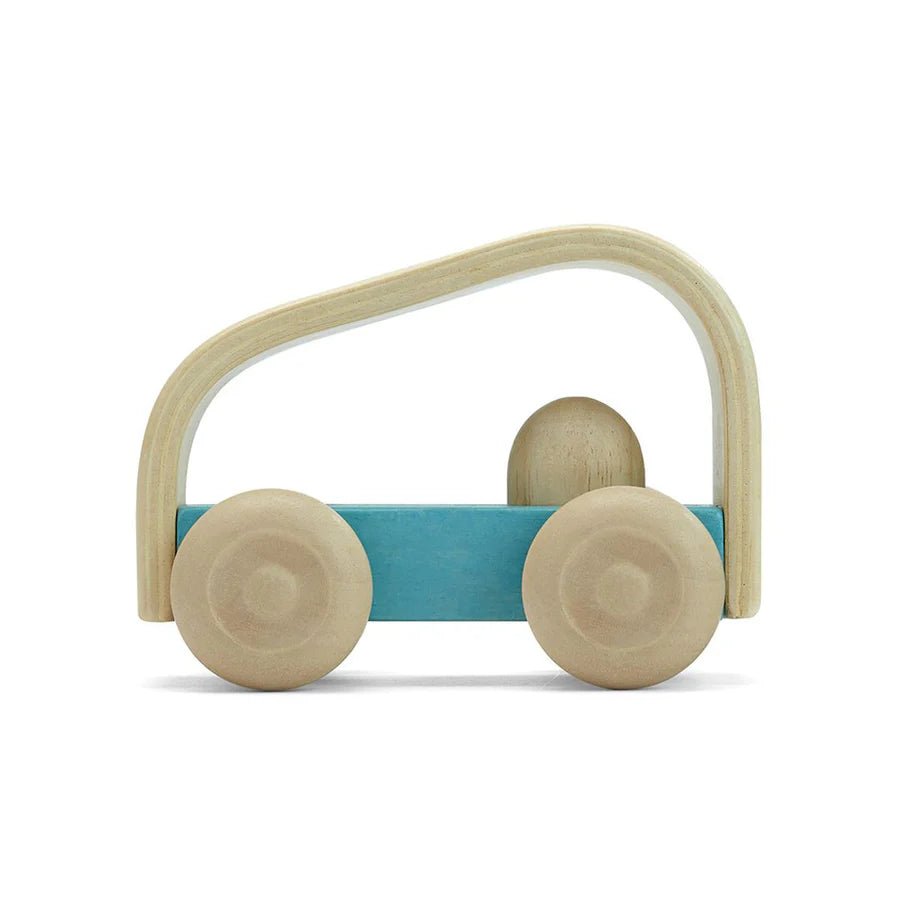 Side view of blue wooden toy car on a white background