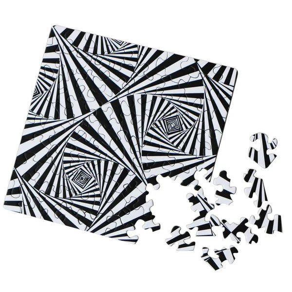Black and white patterned puzzle with scattered pieces on a white background