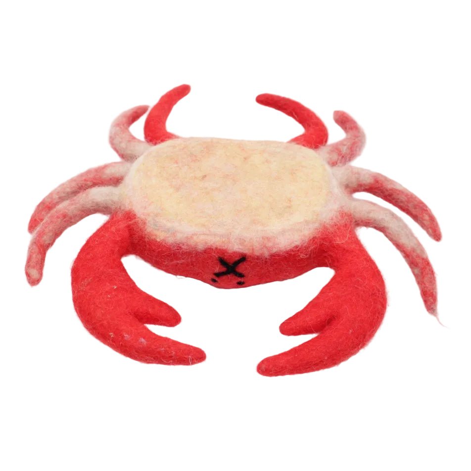 Upside down felted red crab with a tan underbelly on a white background