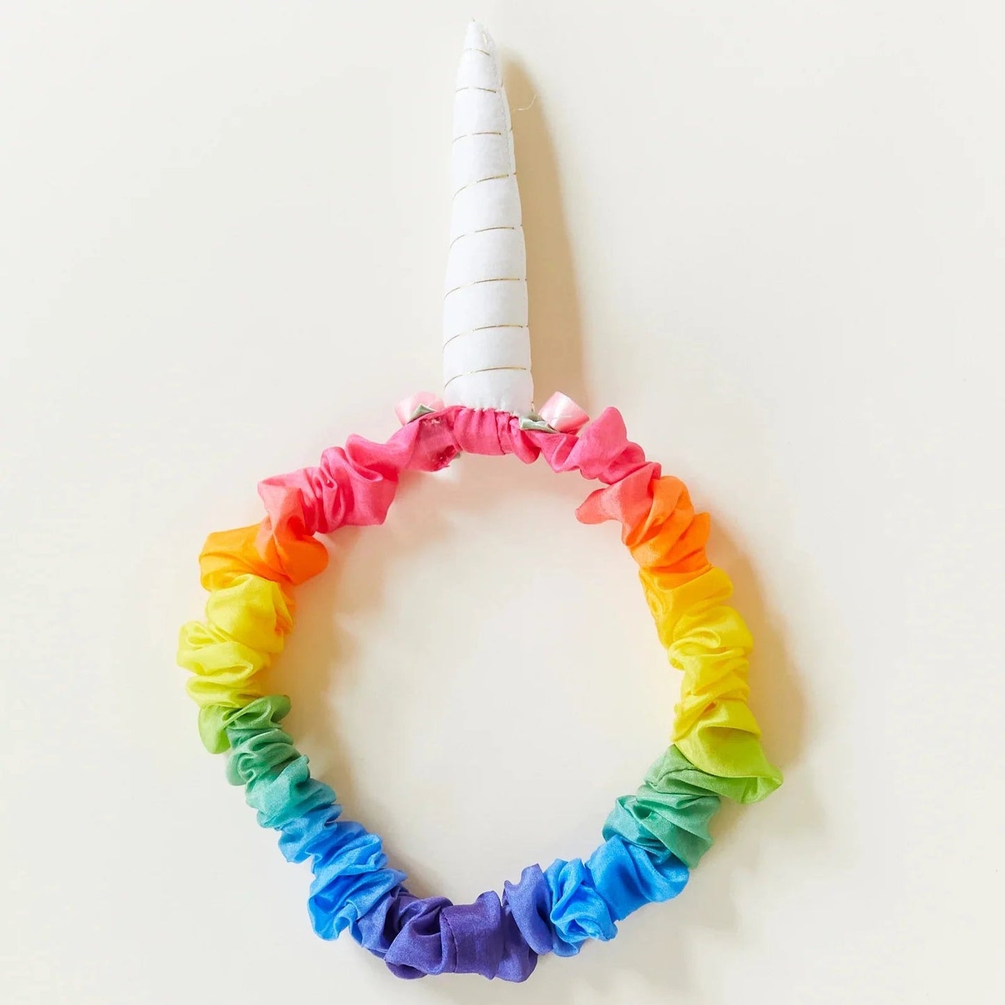 Rainbow colored headband with unicorn horn