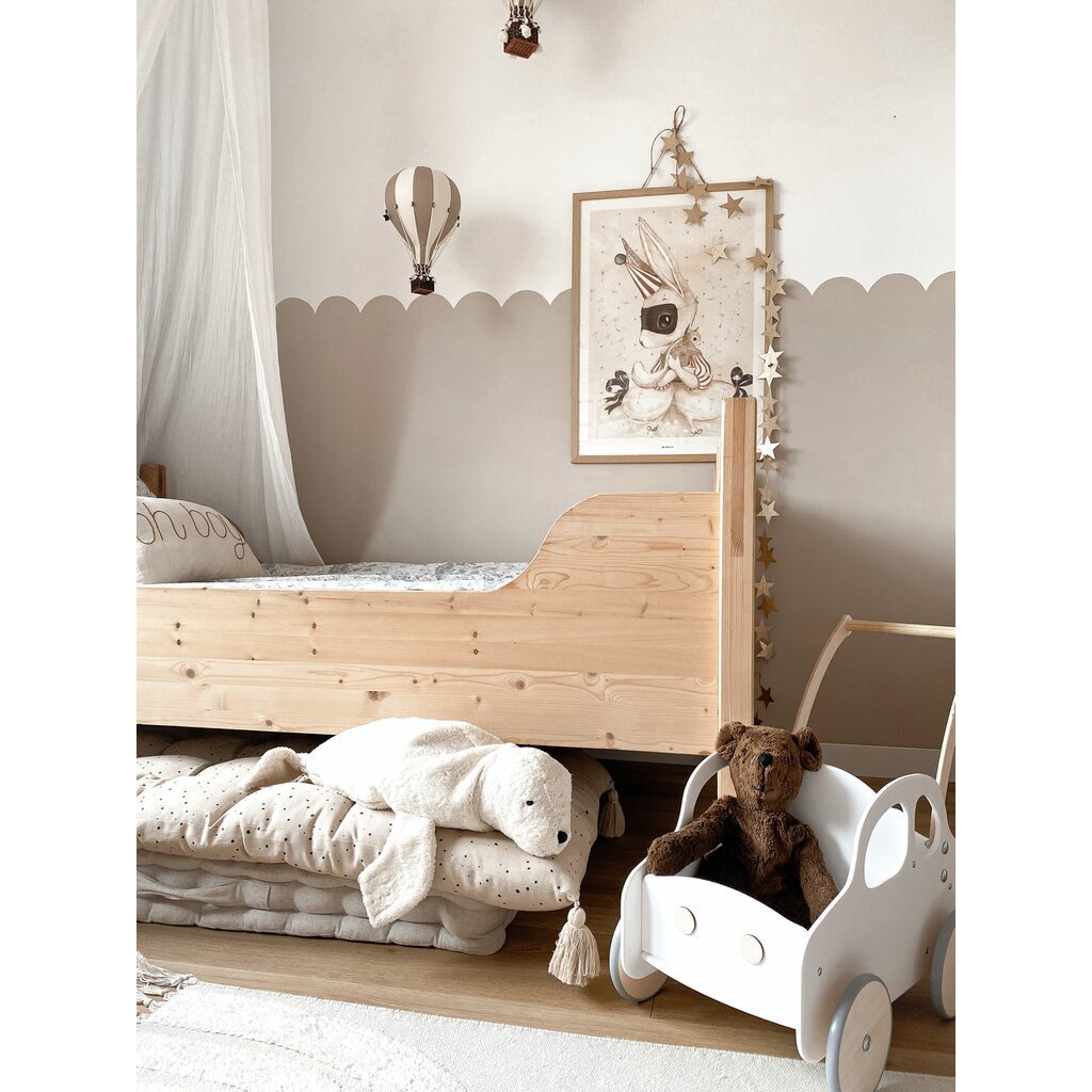 Children's room with wooden bed, Brown Senger teddy bear, and toys on a shelf.