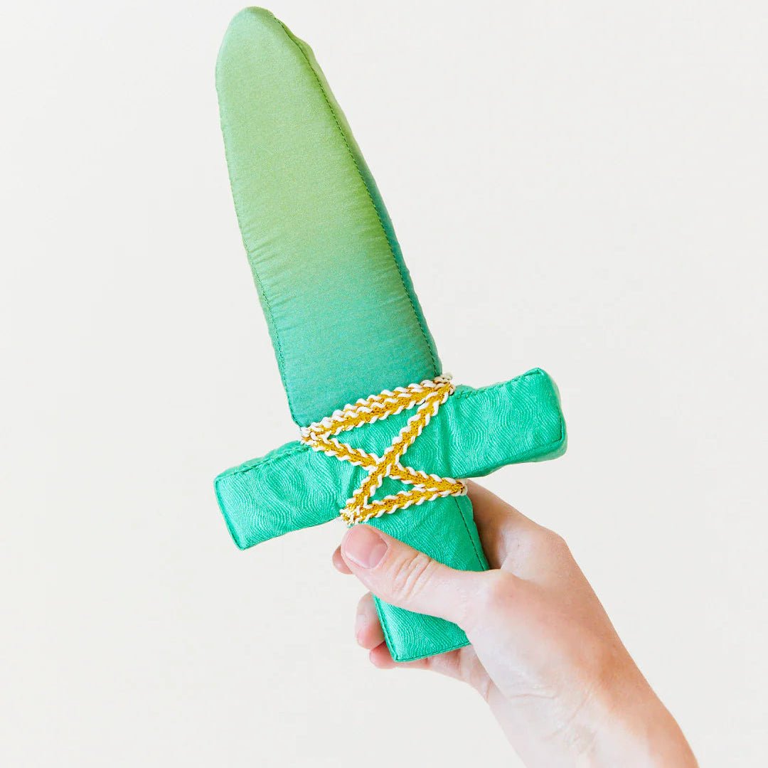 Green foam sword with a yellow rope handle held by a hand on a white background