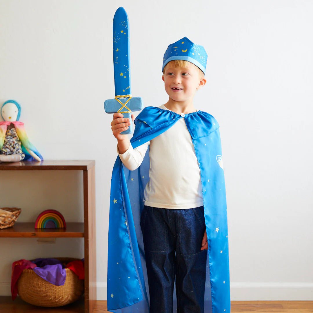 Child wearing a blue star pattern crown and cape, holding blue star pattern sword