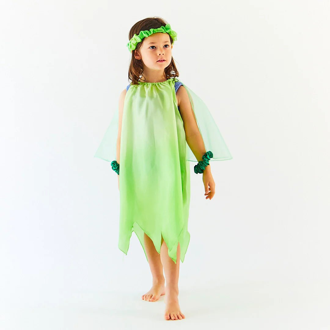 Child wearing a green Tinkerbell costume with wings and headband on a white background