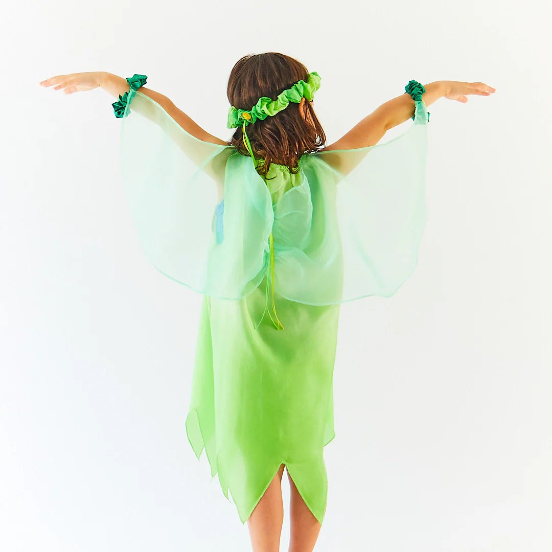 Child wearing green dress with wings