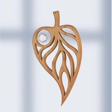 Wooden leaf suncatcher with crystal on a light background