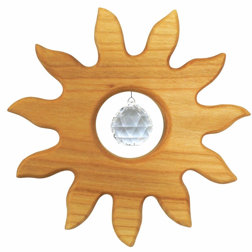 Wooden sun-shaped suncatcher with a clear crystal ball in the center on a white background