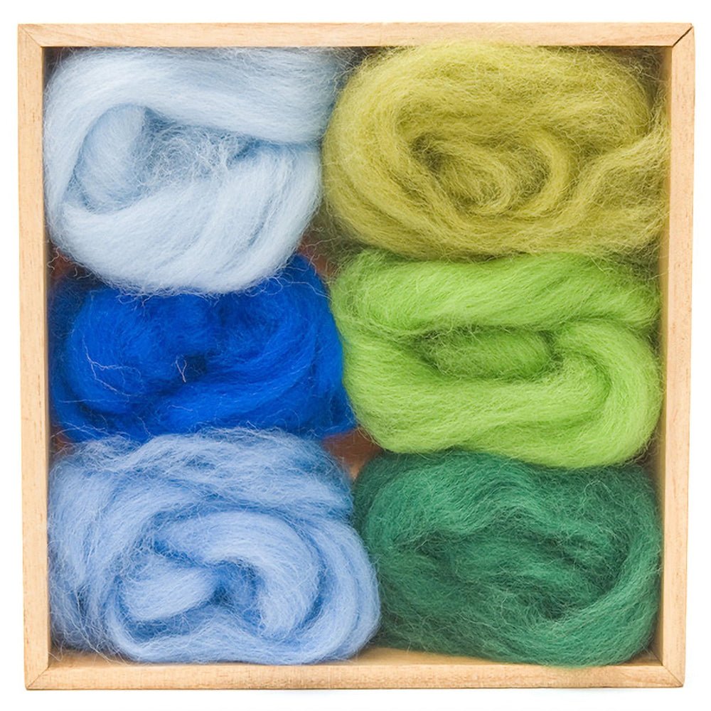 6 balls of felt in various shades of blue and green in a wooden storage box