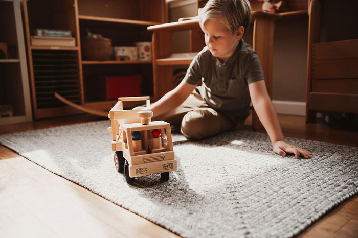 Boy playing with Fagus Fire Engine