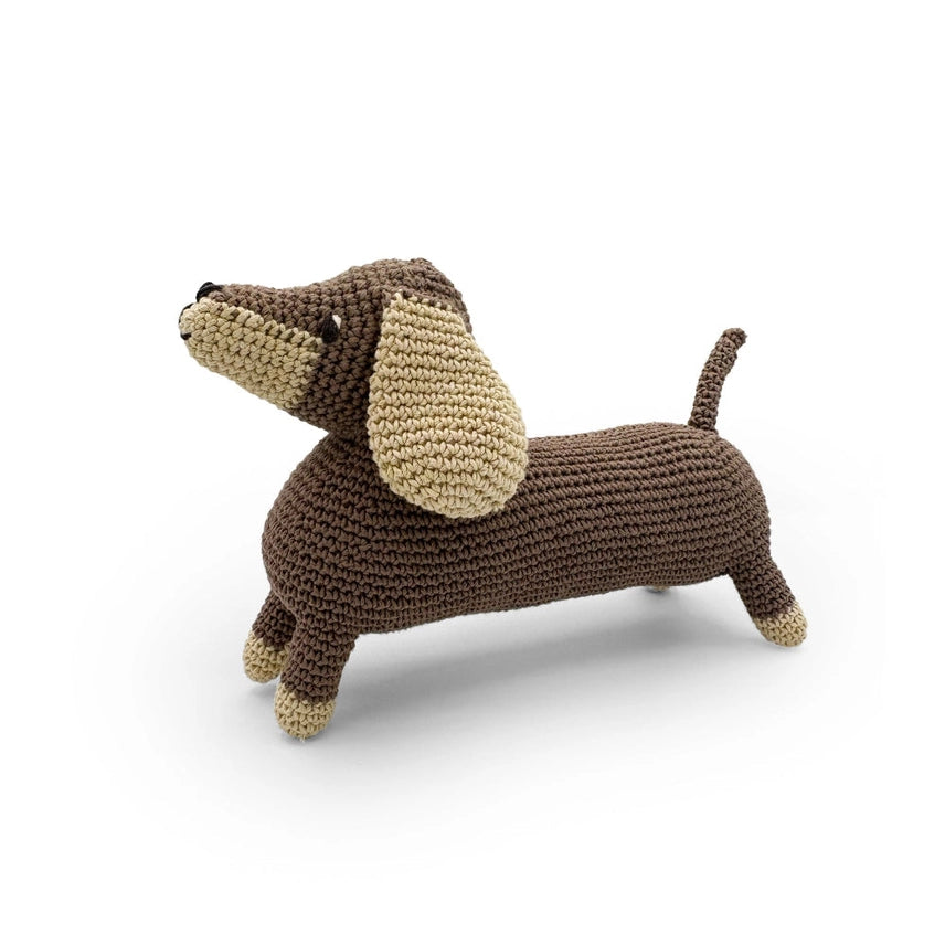 Side view of dachshund stuffed toy on a white background