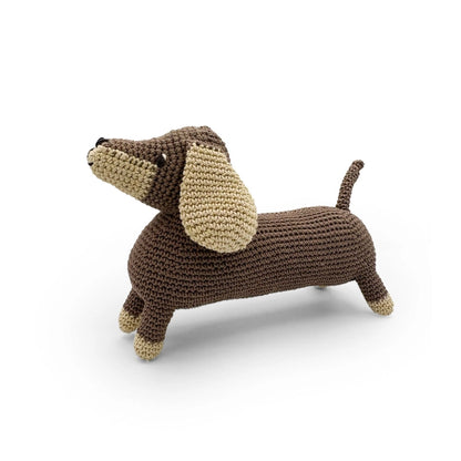 Side view of dachshund stuffed toy on a white background