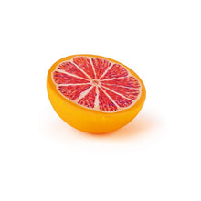 Wooden grapefruit half facing up on a white background