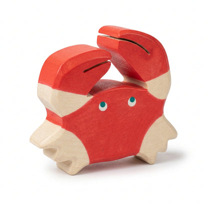 Wooden toy crab figure on a white background