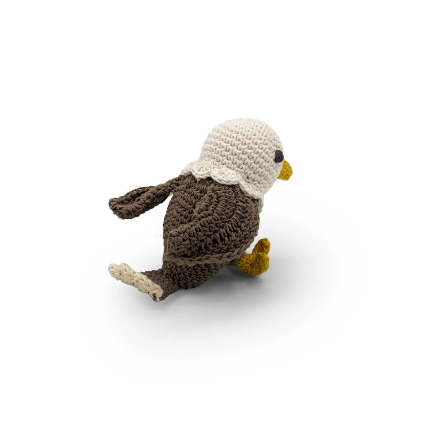 Back view of a crocheted bald eagle toy on a white background