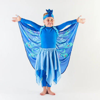 Child wearing an all blue outfit and silk peacock wings on a white background