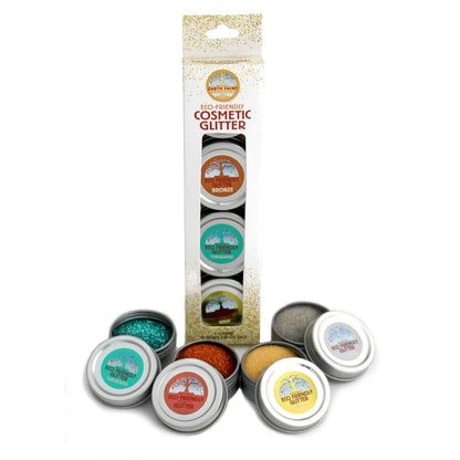Natural Earth Paint eco-friendly cosmetic glitter in a box with tins of glitter in front on a white background