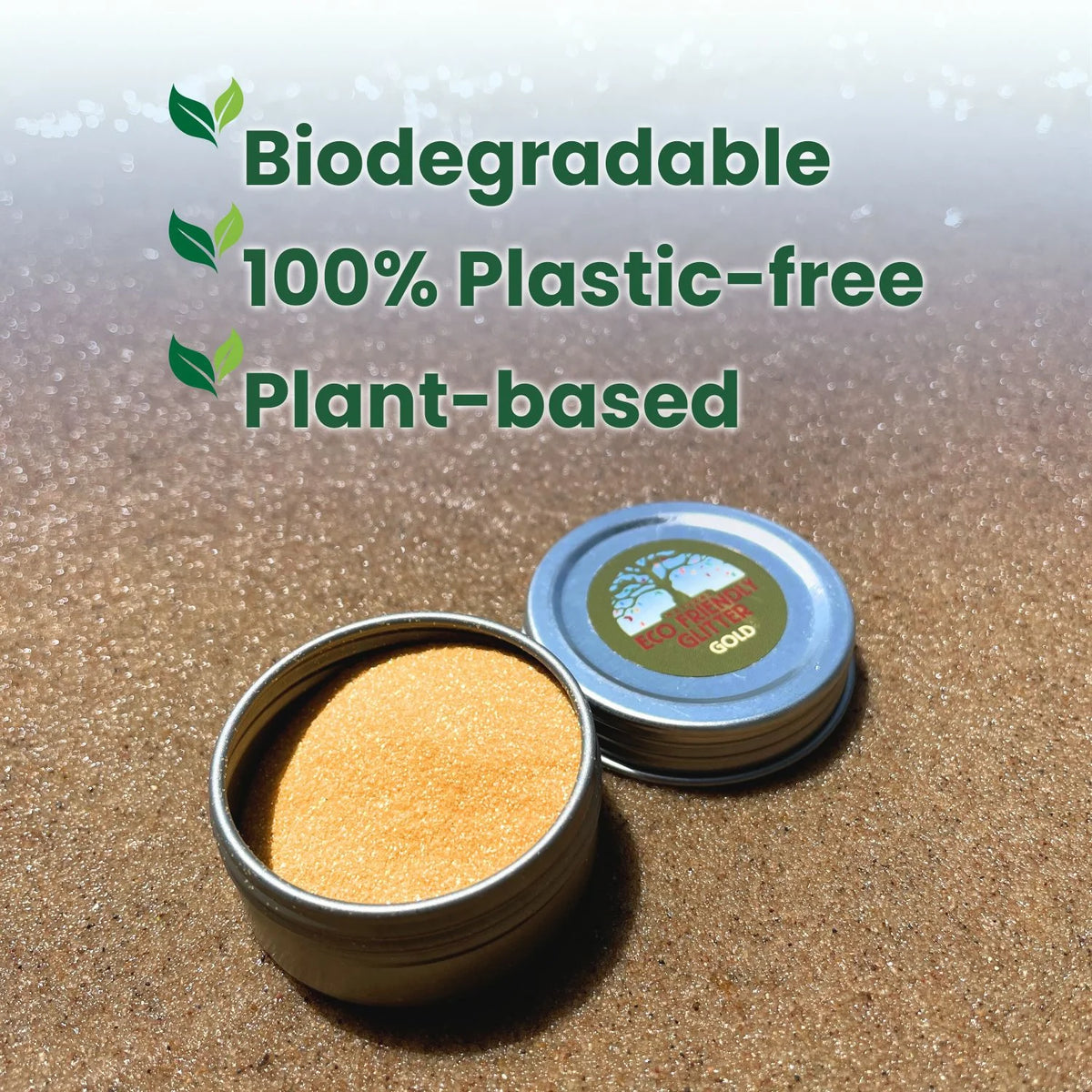 Loose gold glitter in an aluminum tin on a brown surface stating biodegradable and plant-based