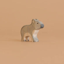 Wooden koala toy figure on a light colored background