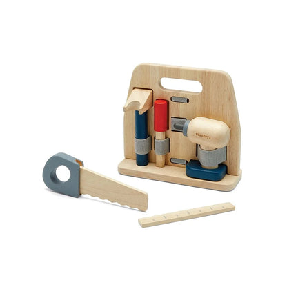 Plan Toys wooden construction tools in a wooden holder on a white background