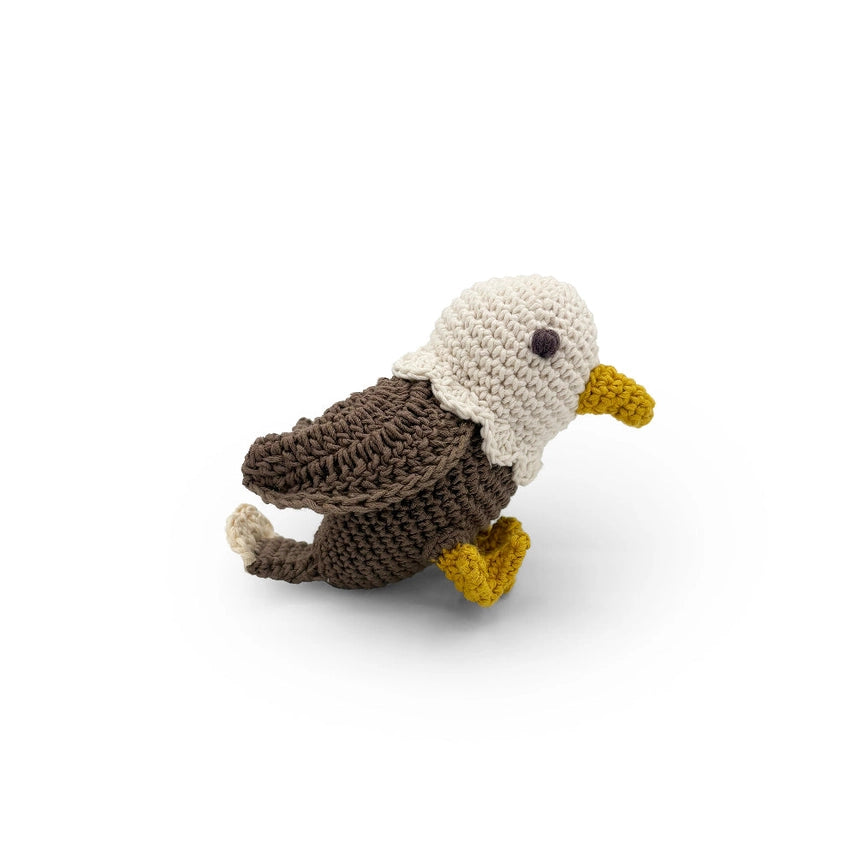 Crocheted bald eagle rattle toy on a white background