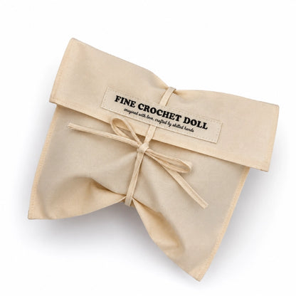 Beige cotton bag that reads "Fine Crochet Doll imagined with love, crafted by skilled hands"