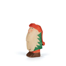 Wooden gnome figurine with a red hat and pants, green coat, and long white beard on a white background