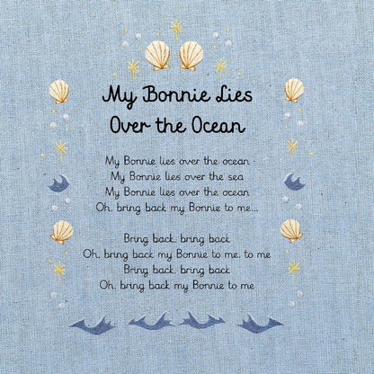 A light blue fabric print featuring the nursery rhyme 'My Bonnie Lies Over the Ocean' with decorative seashells, and stars