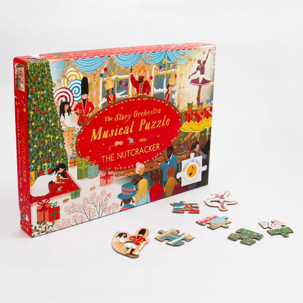 The Story Orchestra's 'The Nutcracker' Musical Puzzle box shown on a clean white background with several loose puzzle pieces scattered in front. The box features a festive, colorful nutcracker-themed illustration with a large red oval title panel.