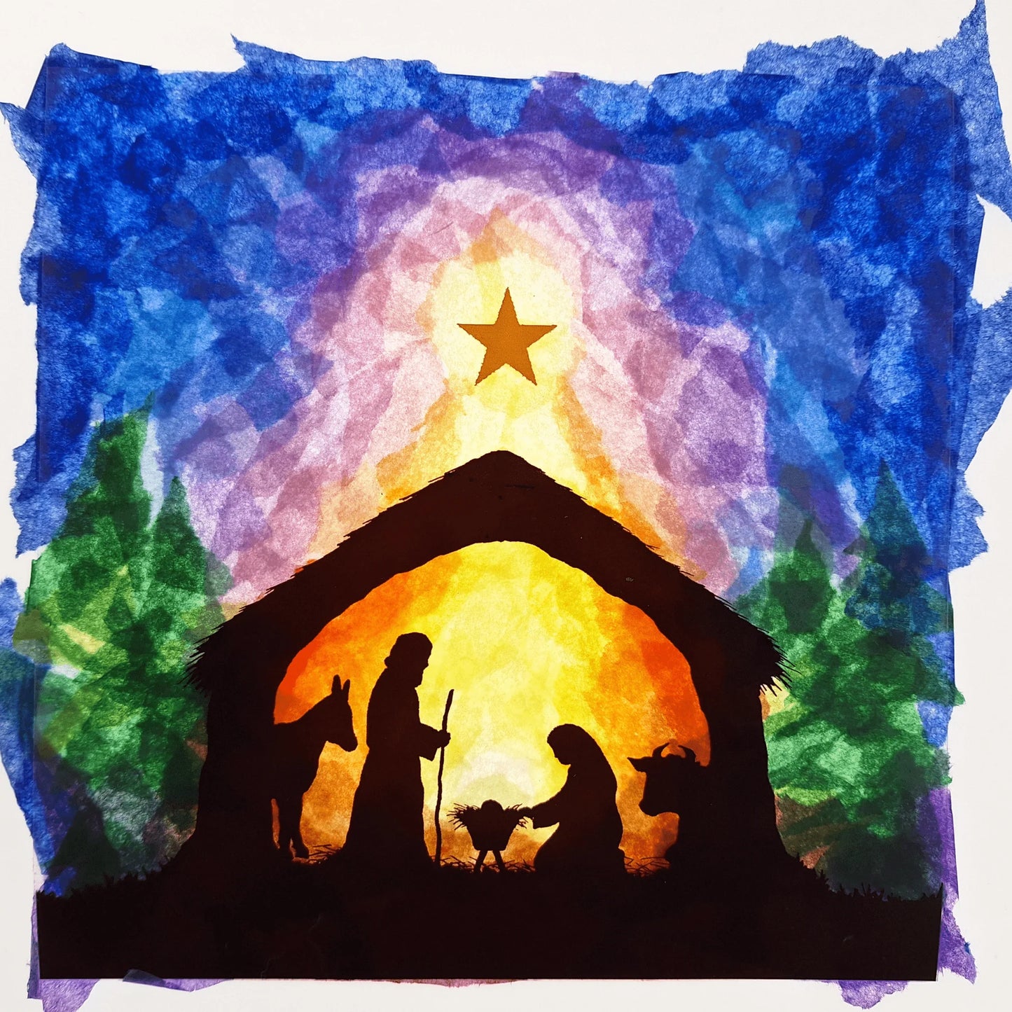 Silhouette of a nativity scene with a star in the sky, surrounded by different colors of kite paper