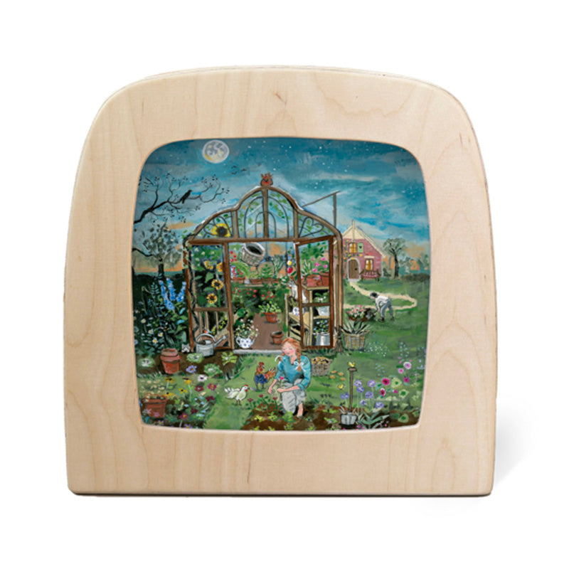 Wooden frame with a painted scene of a garden and greenhouse on a white background