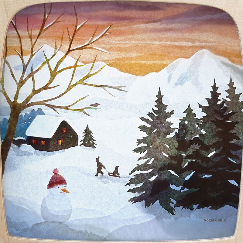 Winter scene with a house, trees, snowman, and children sledding on a snowy landscape.