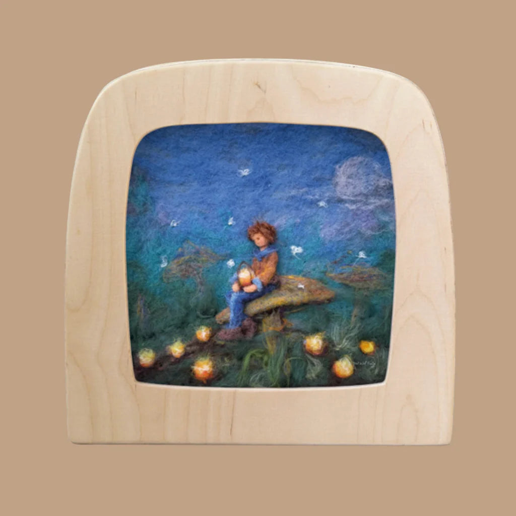 Wooden frame with a scene of a child sitting on a toadstool under a starry sky.