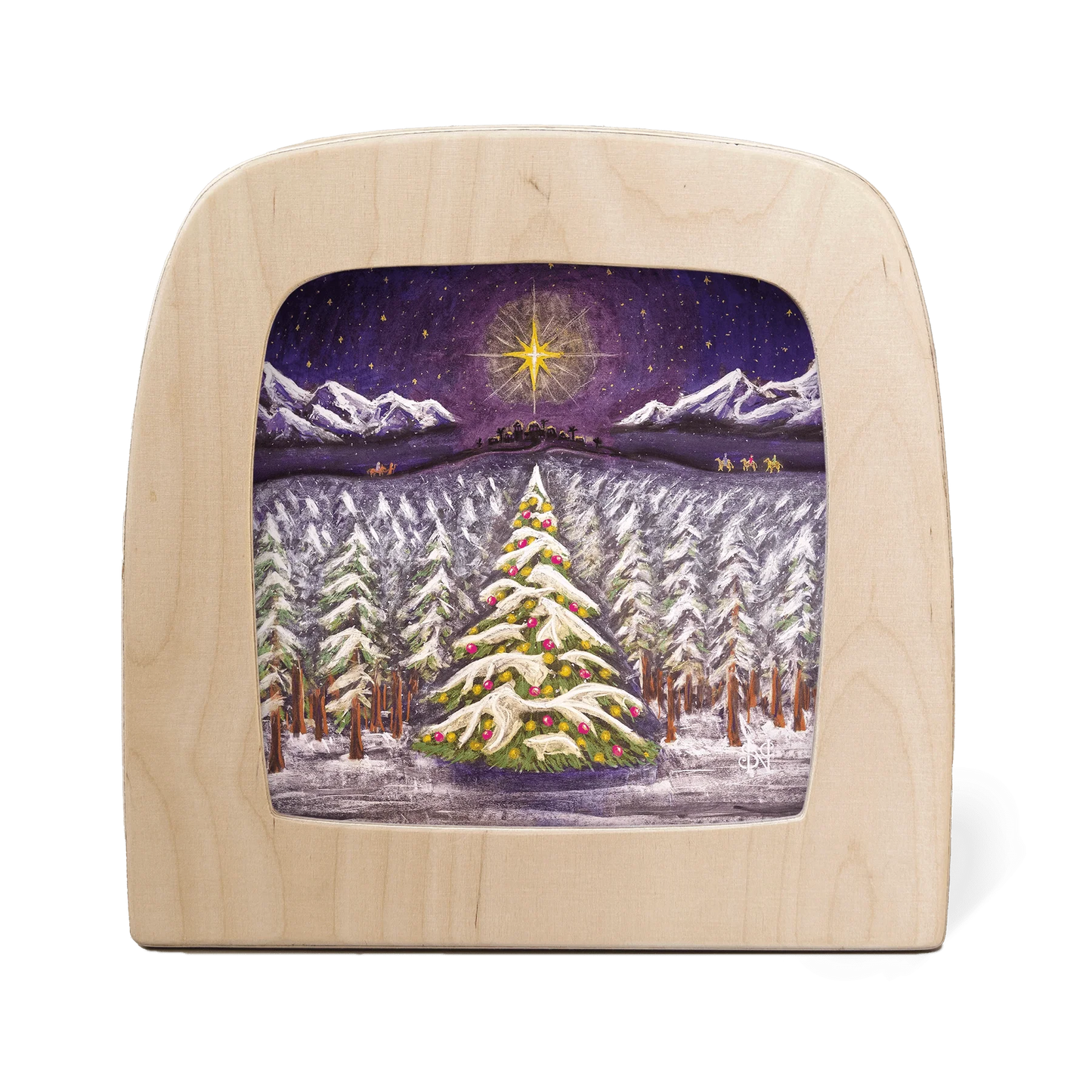 Wooden frame with silhouette of a winter landscape, featuring a large Christmas tree in the foreground and the journey to Bethlehem in the background