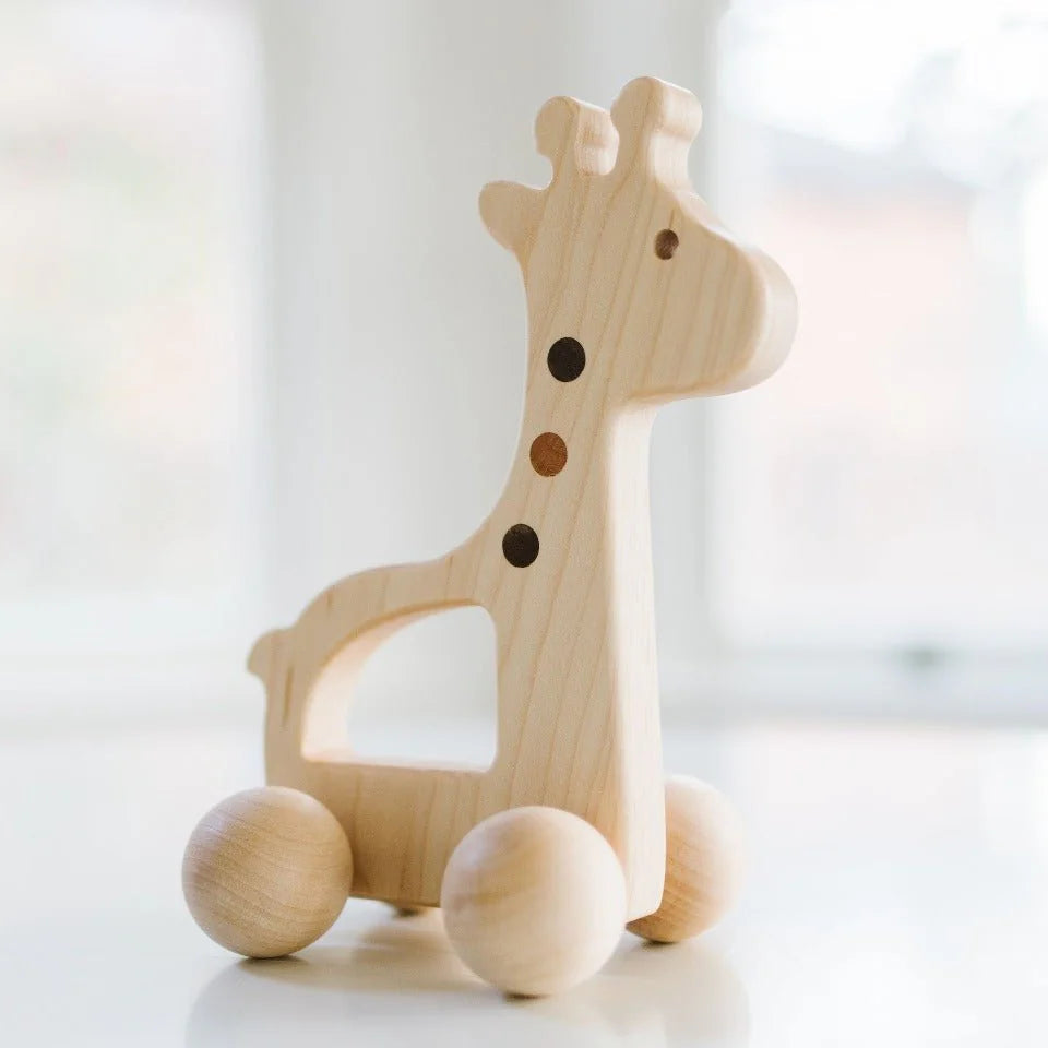 Wooden push toy giraffe on a white background