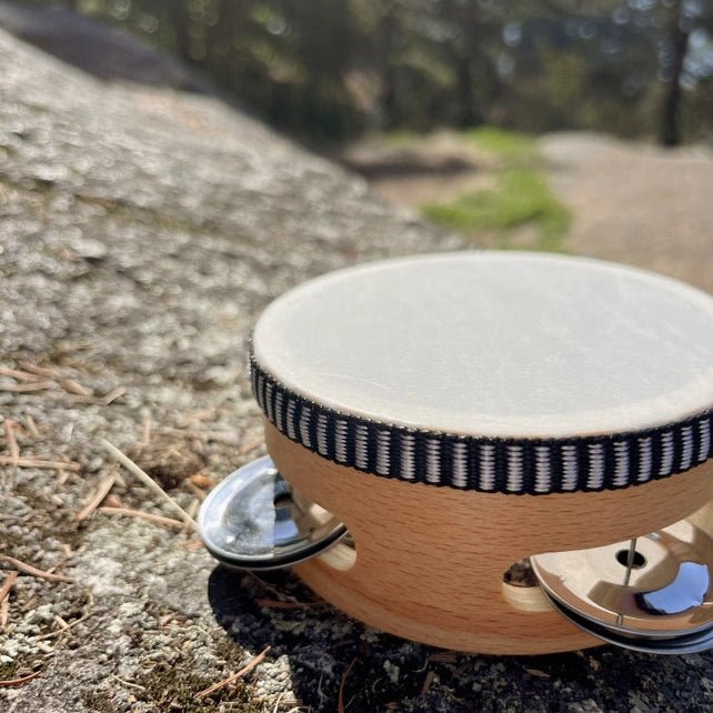 Tambourine on a rock with a natural outdoor background