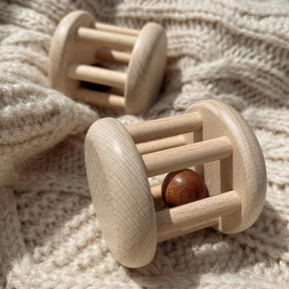 Wooden baby rattles on a soft fabric background