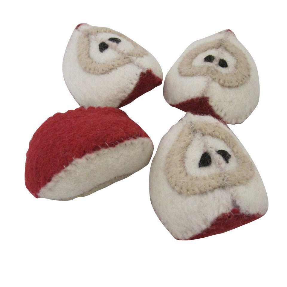 4 felted apple slices on a white background